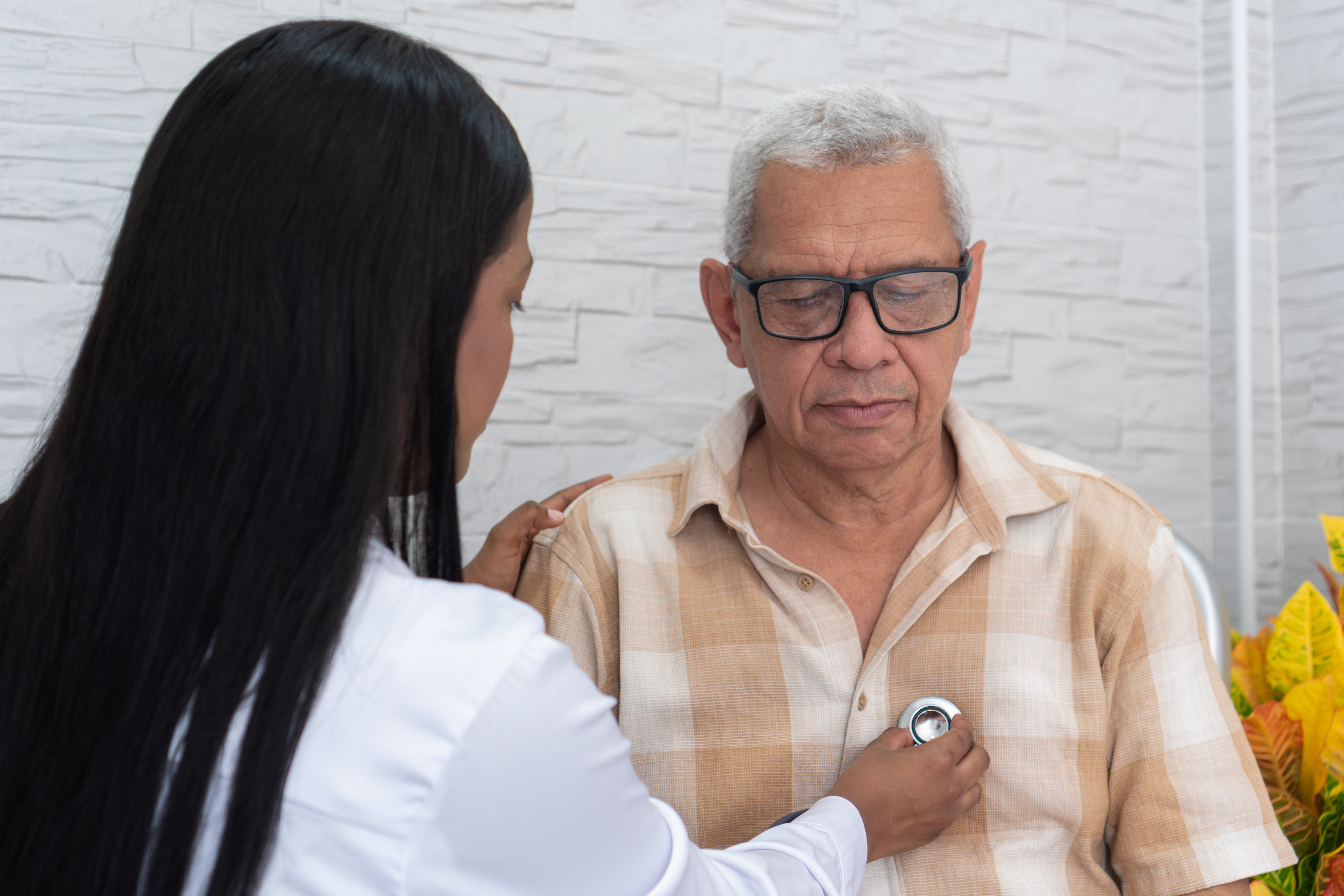 Doctor uses stethoscope on patient